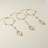 Gold-Plated Stainless Steel Heart Finger Bracelet showing all three gemstone colour variations