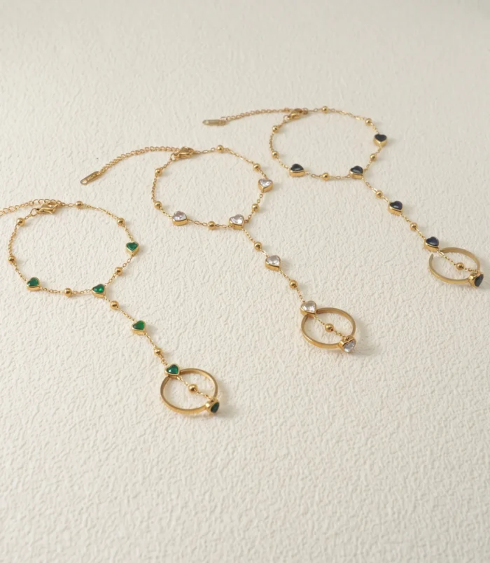 Gold-Plated Stainless Steel Heart Finger Bracelet showing all three gemstone colour variations
