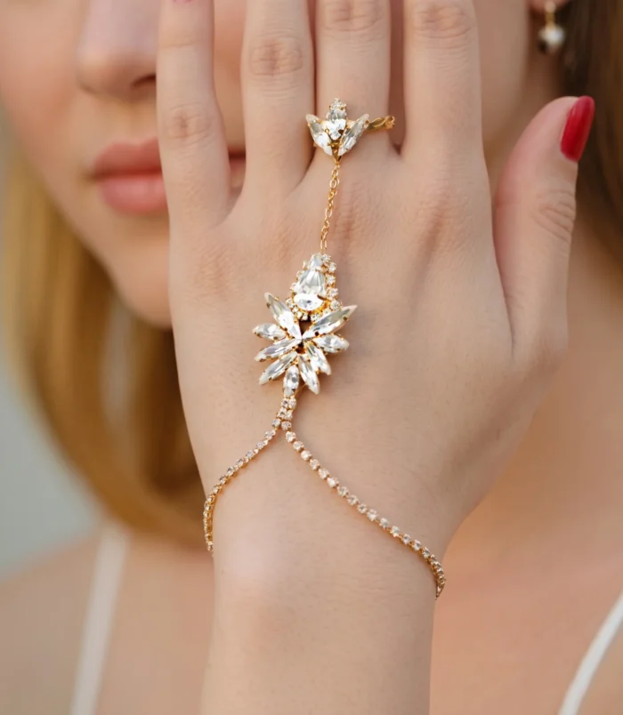 Elegant rhinestone leaf finger bracelet worn on a woman's hand.