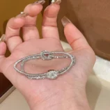 Gold & Silver Wire Wrapped Bracelet held in palm highlighting the silver colour variation.