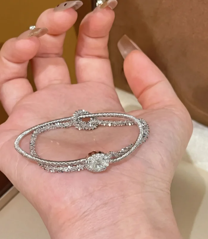 Gold & Silver Wire Wrapped Bracelet held in palm highlighting the silver colour variation.