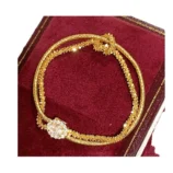 Gold & Silver Wire Wrapped Bracelet resting inside an elegant red display box