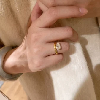 Beautiful gold teardrop zircon ring worn gracefully on a woman's hand.