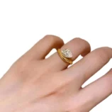 Gold Teardrop Zircon Ring held close-up showing the side profile and stone setting.