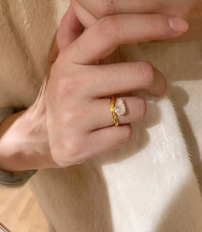 Beautiful gold teardrop zircon ring worn gracefully on a woman's hand.