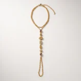 Full flat lay view of the gold titanium steel finger bracelet with extension chain