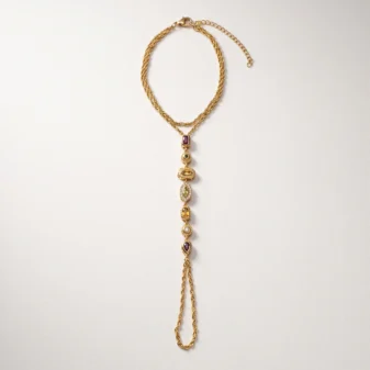 Full flat lay view of the gold titanium steel finger bracelet with extension chain