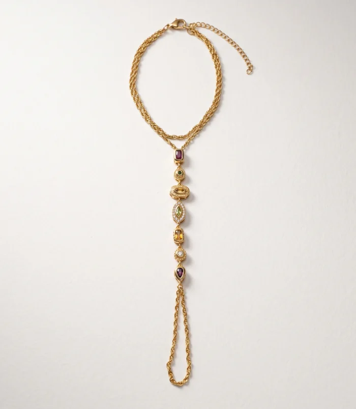 Full flat lay view of the gold titanium steel finger bracelet with extension chain