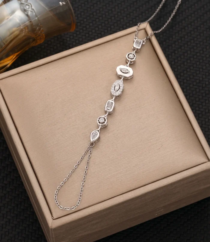 Silver white diamond variant of the finger bracelet displayed on a gift box