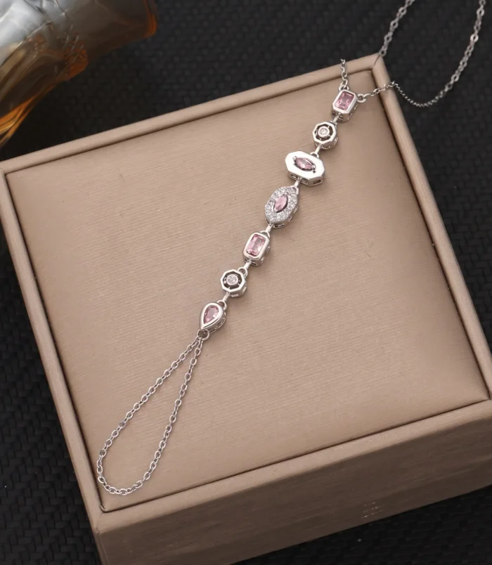Silver pink diamond variant of the finger bracelet showcased on a presentation box