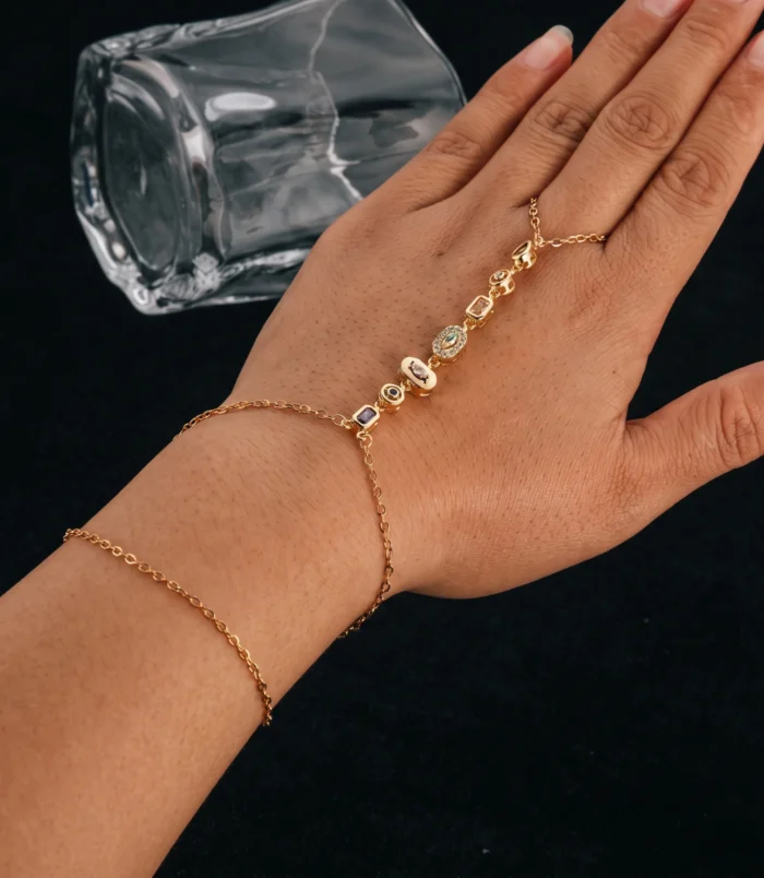 Elegant gold titanium steel finger bracelet worn on hand showing sparkling stone details