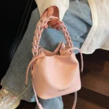 Multi-Colour Woven Handle Bucket Bag for Women pink variant held by the braided strap