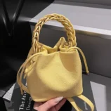 Multi-Colour Woven Handle Bucket Bag for Women in yellow showcasing the pebbled leather texture