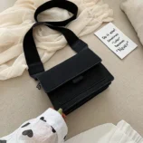 Multicolour PU leather square crossbody bag resting on hand in black