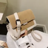 Multicolour PU leather square crossbody bag held to show khaki texture