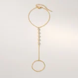 Multicolour rhinestone finger bracelet for women flat lay showing gold plating with clear white stones.