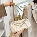 Pleated Chain Shoulder Bag for Women reflecting in a wooden mirror.