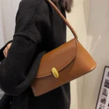 Light brown vintage bag worn comfortably on the shoulder