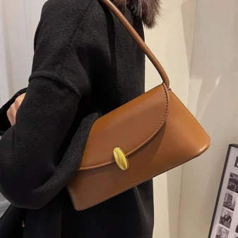 Light brown vintage bag worn comfortably on the shoulder
