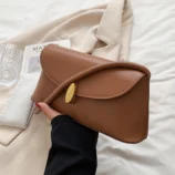 Close-up of the light brown variant held over a white jacket