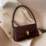 Dark brown style resting aesthetically on a light blazer