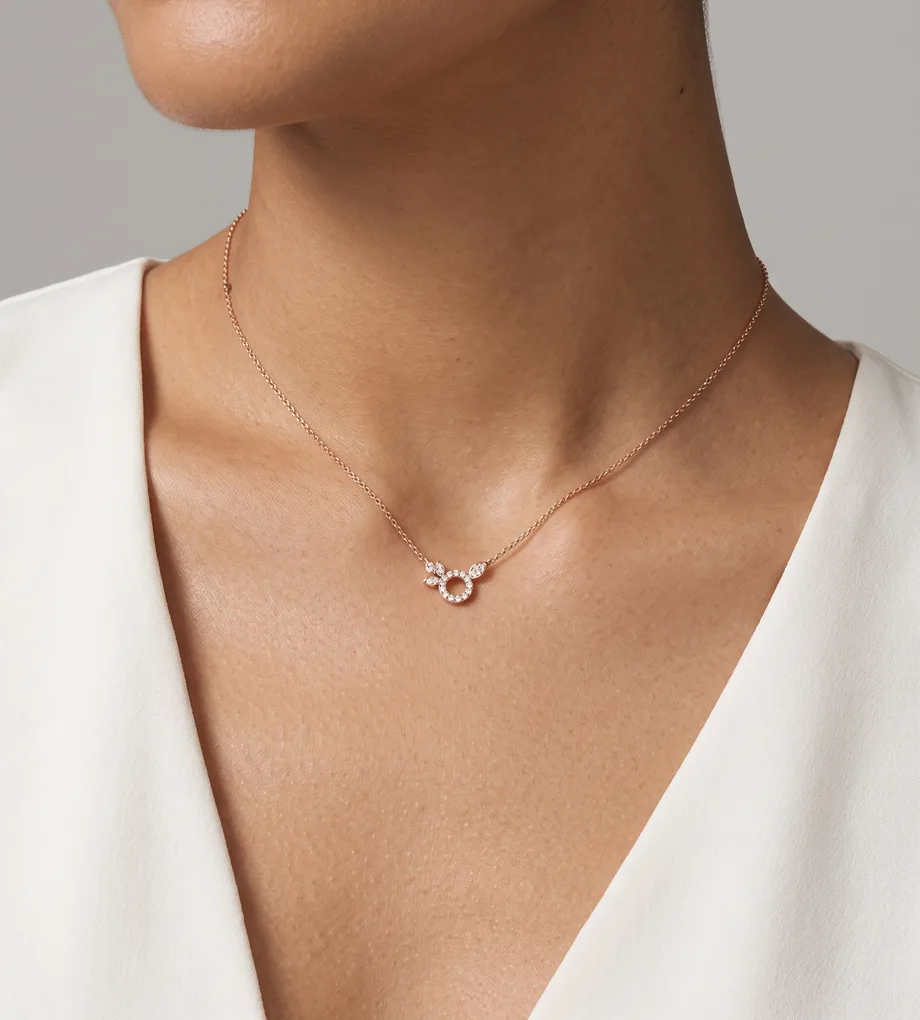 Woman wearing a delicate rose gold necklace with a crystal circle pendant
