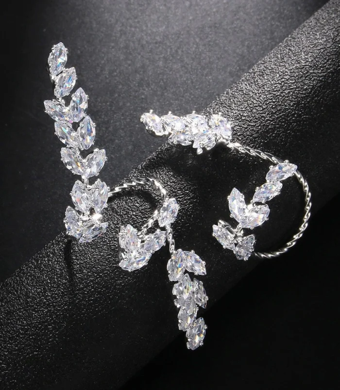 Silver Zircon Leaf Open Ring for Women displayed on a dark cylinder