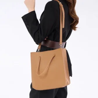 Solid Colour PU Leather Tote Bag for Women worn comfortably across the body by a model.