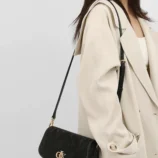 Textured PU shoulder bag for women worn crossbody by a model