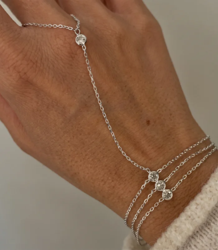 Gold and Silver Three-Layer Finger Bracelet shown in silver worn elegantly on a hand.