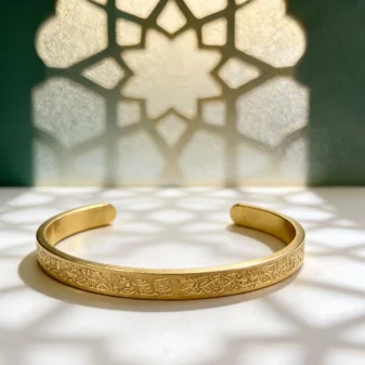 Vintage embossed stainless steel cuff bracelet gold color showing inner diameter measurements.