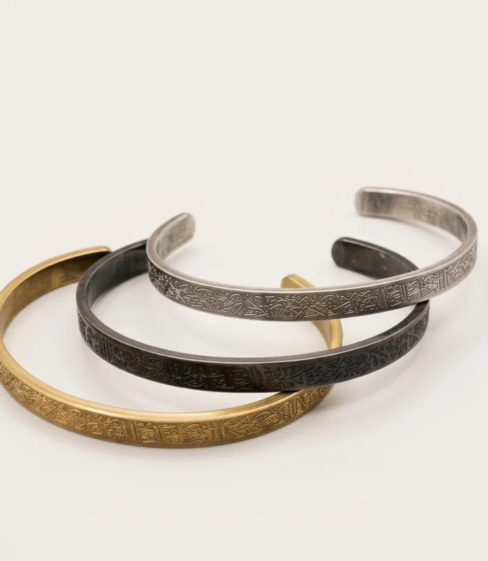 Group view of three stainless steel cuff bracelets in different metallic finishes.